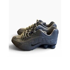 grey Nike Shox R4 sneakers featuring the signature columnar cushioning springs
